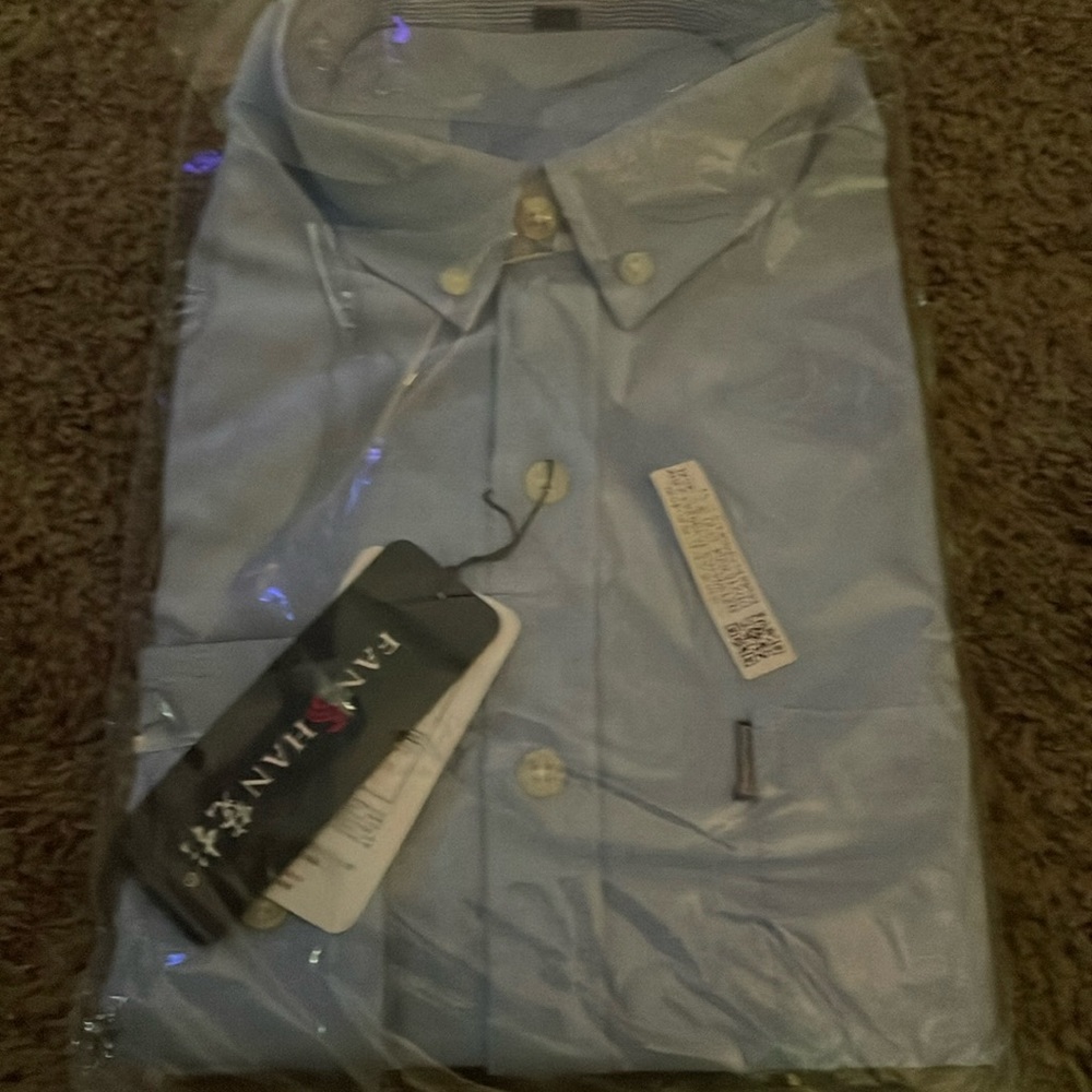 This new button-down shirt is like a light blue denim with pearl white button dn